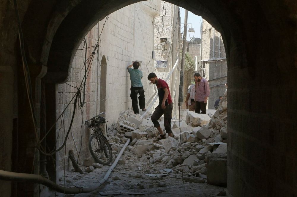 Residents inspect their damaged homes after an airstrike on the opposition-held part of Aleppo.