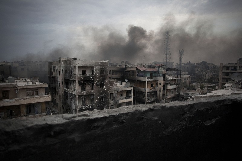 In this Oct. 2, 2012 file photo, smoke rises over Saif Al Dawla district, in Aleppo, Syria. With rebels and regime forces each promising to unite the divided city, Aleppo is once again a main battlefield in Syria's devastating civil war. (AP Photo)