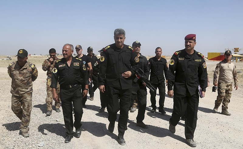 Commander of the Fallujah operation, Lt. General Abdul-Wahab al-Saadi, center, inspects his forces ahead of an operation to re-take the Islamic State-held City of Fallujah, outside Fallujah, Iraq, Sunday, May 29, 2016 (AP Photo)