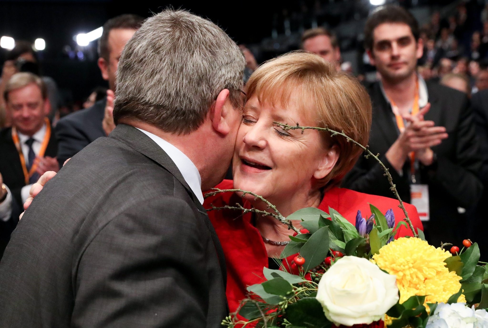 The Interior Minister of the German state of Mecklenburg-Western Pomerania Lorenz Caffier (L) congratulates German Chancellor Merkel. (AP Photo) 
