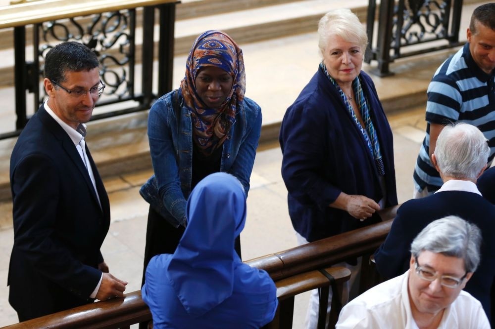 A Muslim woman shakes hands with a nun during a Mass in tribute to slain priest Jacques Hamel in the Rouen Cathedral, July 31.