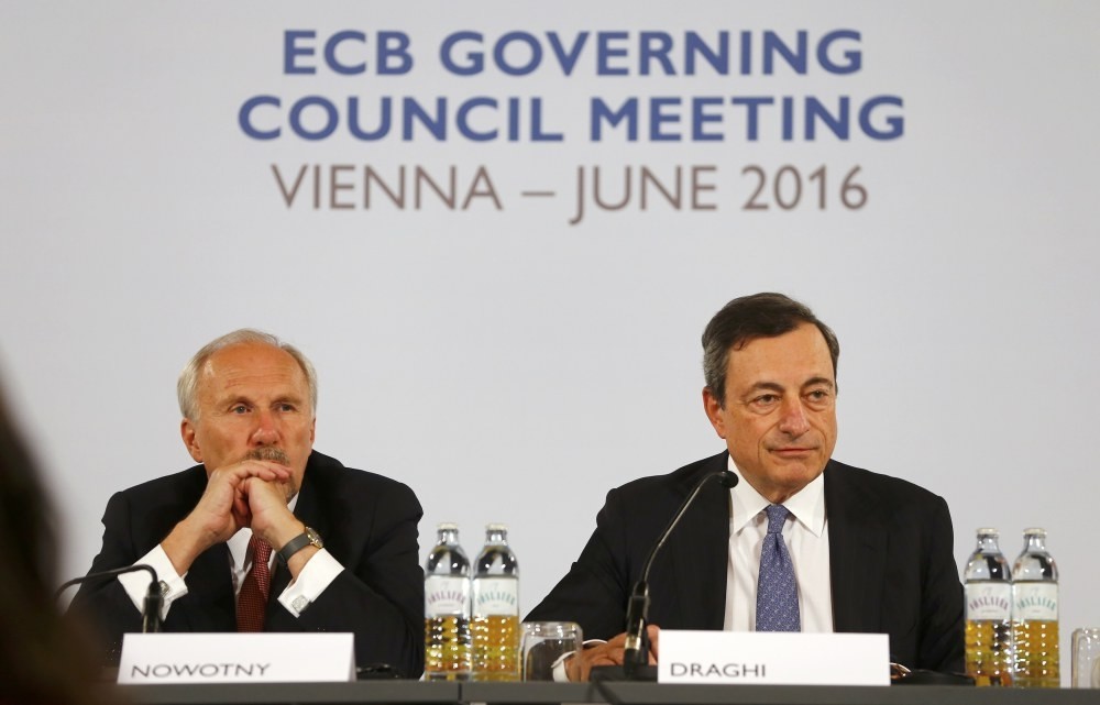 Governor of the Austrian National Bank and European Central Bank (ECB) Governing Council member Ewald Nowotny (L) and ECB Governor Draghi attend a news conference in Hofburg palace in Vienna, Austria, on June 2.