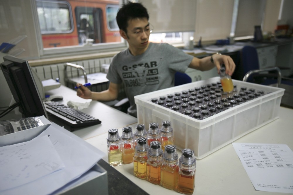 Urine samples from Chinese athletes are recorded upon arriving at the Chinese Anti-Doping Agency in Beijing in 2008. The IOC said athletes caught for doping in retesting of samples from the 2008 Olympics.