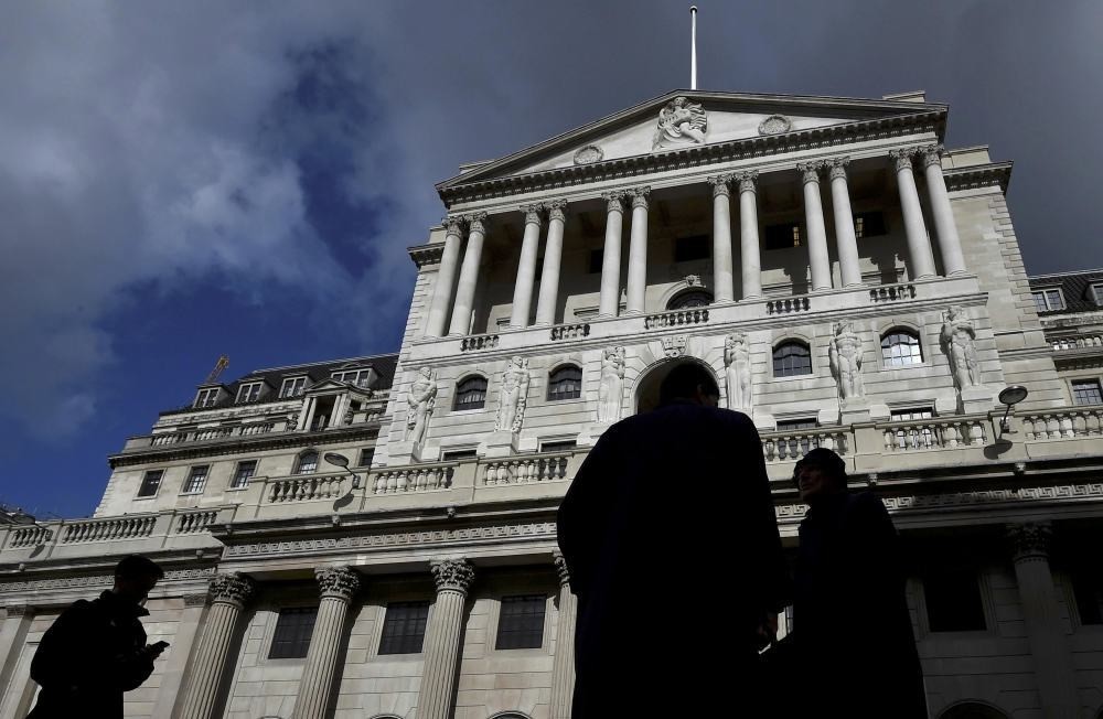 City workers walk past the Bank of England in the City of London. (Reuters Photo)