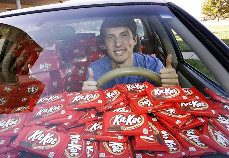 In this Nov. 3, 2016, photo Hunter Jobbins, freshman at Kansas State University, poses in his car filled with nearly 6,500 Kit Kat bars in Manhattan (AP Photo)