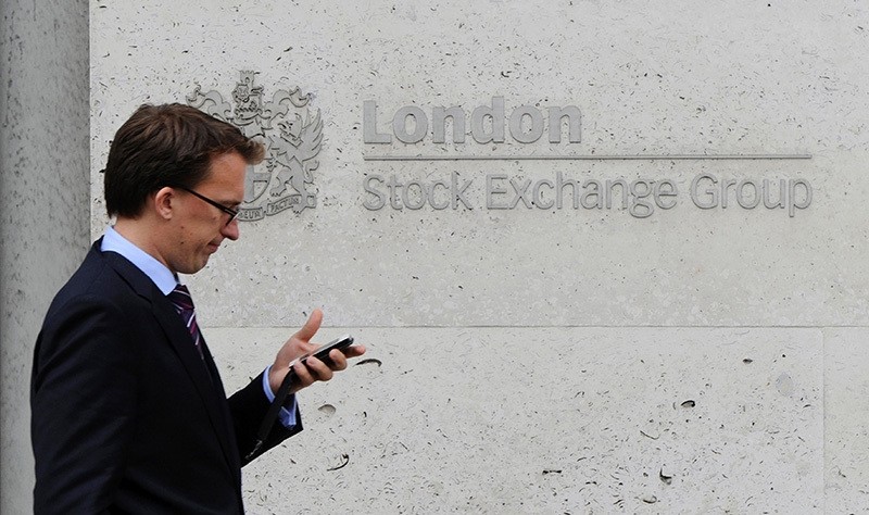 This file photo taken on September 22, 2011 shows a man walking past the London Stock Exchange, in central London. (AFP)