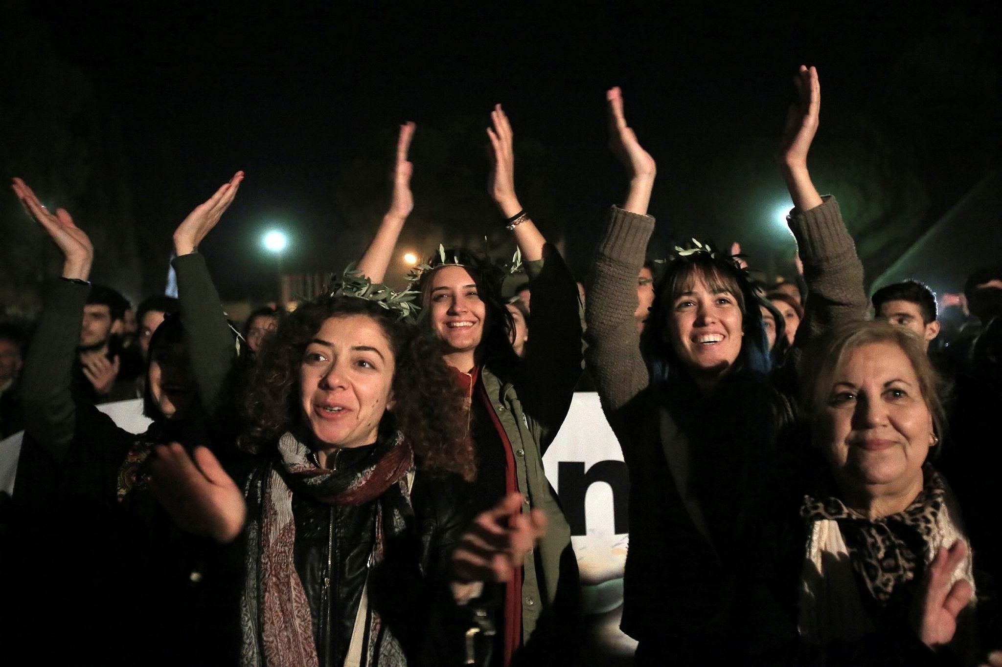 Greek and Turkish Cypriots clap and sing during a peace rally to support the peace talks inside the UN buffer zone ,Green Line, (AP Photo)