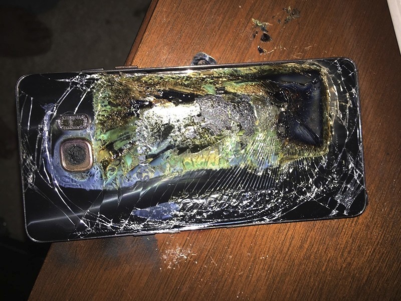 This Sunday, Oct. 9, 2016, photo shows a damaged Samsung Galaxy Note 7 on a table in Richmond, Va., after it caught fire earlier in the day. (AP Photo)