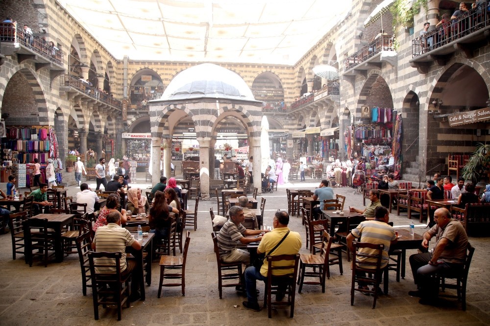 This file photo shows a group of artisans sitting in a bazaar in Sur, Diyarbaku0131r. The recently announced investment and development initiative is causing quite a stir in the business world.