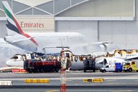 An Emirates airlines Boeing 777-300 A6-EMW plane flight number EK521 from Trivandrum to Dubai lays on the ground in Dubai airport after being gutted by fire due to a mechanical failure at Dubai international airport (EPA Photo)