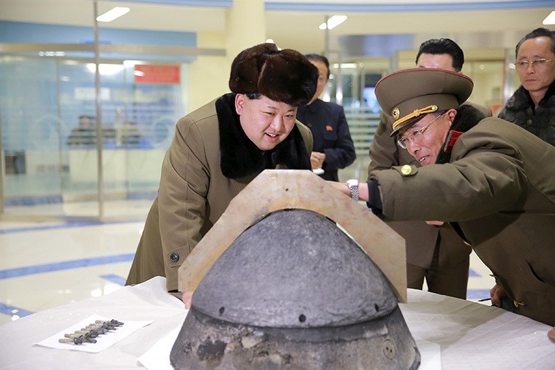N. Korean leader Kim Jong Un looks at a rocket warhead tip after a simulated test of atmospheric re-entry of a ballistic missile (Reuters)