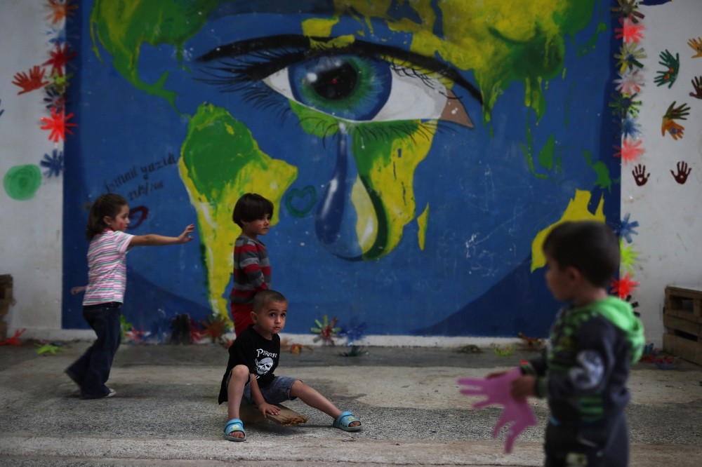 Children playing in front of a mural at Ritsona refugee camp, north of Athens, Sept. 13, 2016.