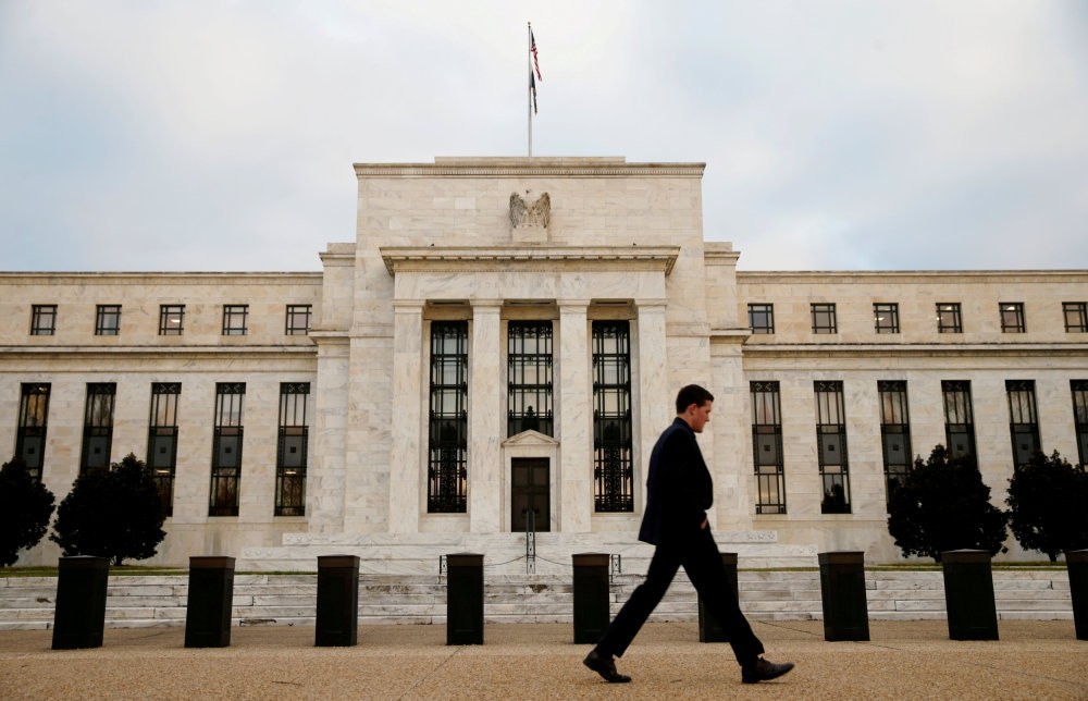 A man walks past the Federal Reserve Bank in Washington, D.C., U.S.