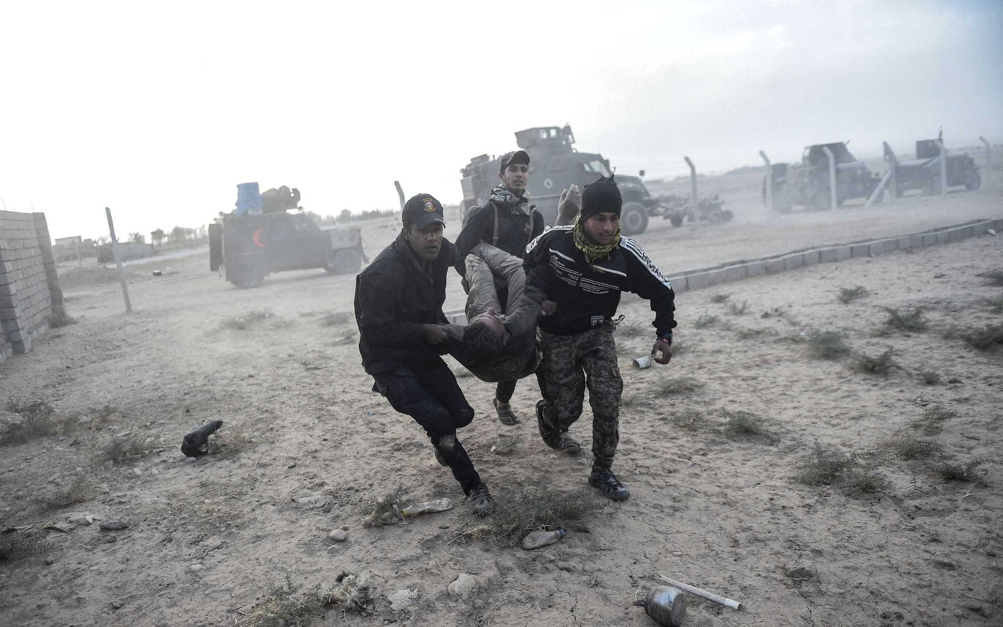 The Iraqi Counter Terrorism Section (CTS) members carry an injured comrade during clashes with Daesh near the village of Bazwaya, on the eastern edges of Mosul, on Oct 31.