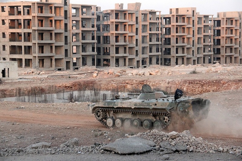 Opposition fighters drive a tank in an eastern regime sieged neighborhood of Aleppo as opposition fighters pressed an offensive on August 5, 2016. (AFP Photo)