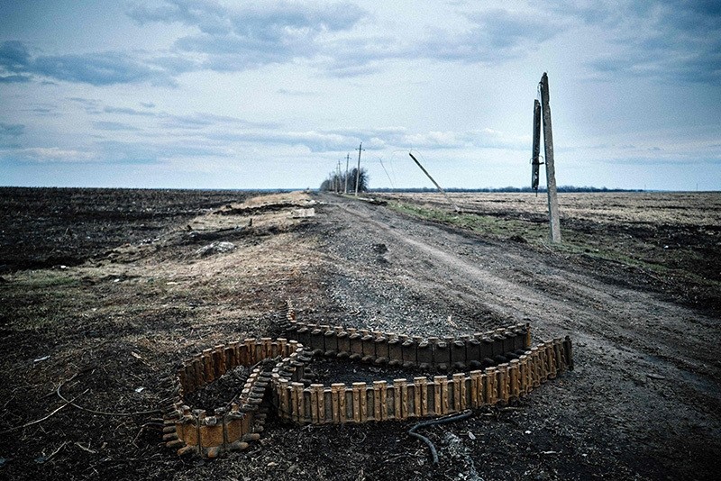 This file photo taken on April 06, 2015 shows a chain of destroyed Armour Personnel Carrier on the ground in a field near the village of Nikishino, eastern Ukraine. (AFP Photo)