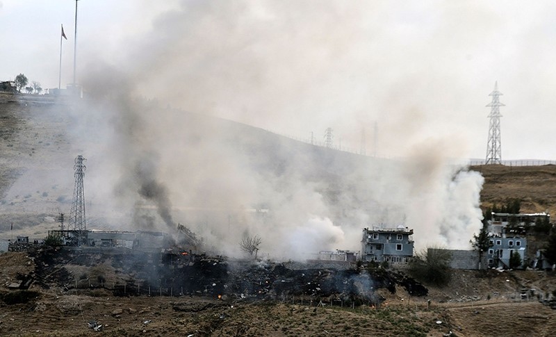 Smoke rises from damaged police headquarters after PKK terror attack killed 11 Turkish police officers and injured 78 people on August 26, 2016 in Cizre (AFP Photo)