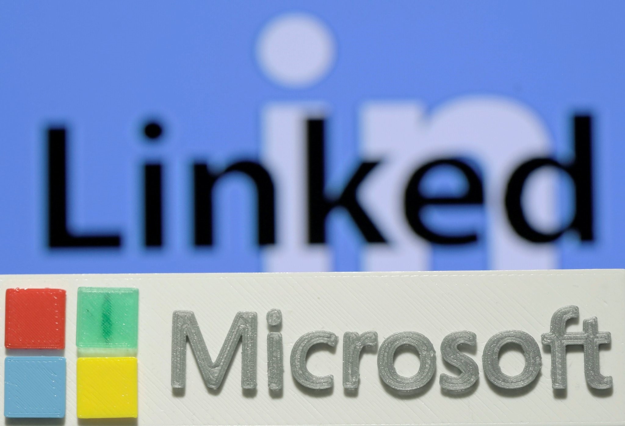 A 3D PRINTED LOGO OF MICROSOFT IS SEEN IN FRONT OF A DISPLAYED LINKEDIN LOGO IN THIS ILLUSTRATION TAKEN JUNE 13, 2016. (REUTERS Photo)