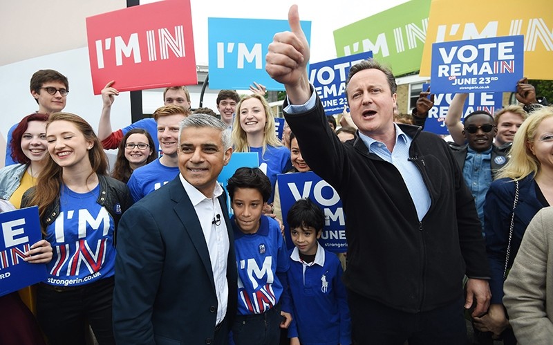British Prime Minister David Cameron (R) and Mayor of London Sadiq Khan (L) greet supporters during the launch of the battle bus for the 'Remain In' campaign (EPA Photo)