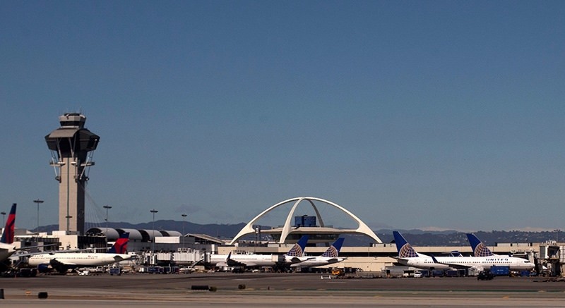 United Airlines planes are seen in the foreground of the Los Angeles International Airport (LAX) and its air traffic control tower on February 20, 2013. Picture taken on February 20, 2013 (Reuters File Photo)