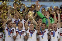 Germanyu2019s Bastian Schweinsteiger holds up the 2014 World Cup trophy as the team celebrates their 1-0 victor over Argentina after the World Cup final match between Germany and Argentina at the Maracana Stadium in Rio de Janeiro.