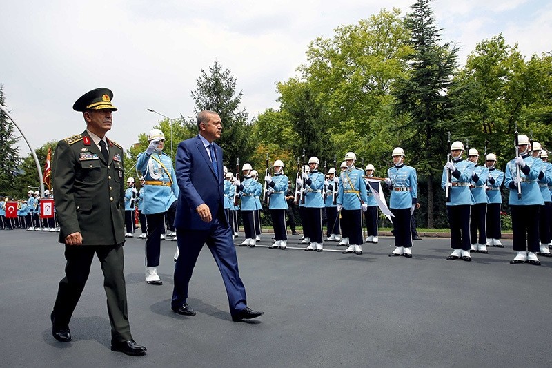 Turkey's President Recep Tayyip Erdou011fan (R) and Chief of Staff Gen Hulusi Akar, review a military honor guard at the military headquarters in Ankara, Turkey, on Wednesday, Aug. 3, 2016. (Kayhan u00d6zer / Presidential Press Service, Pool Photo via AP)