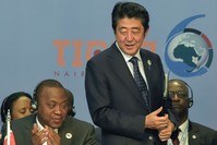Japanese Prime Minister Shinzo Abe (R) stands next to Kenyau2019s President Uhuru Kenyatta (L) during the opening of the Tokyo International Conference on African Development in Nairobi.