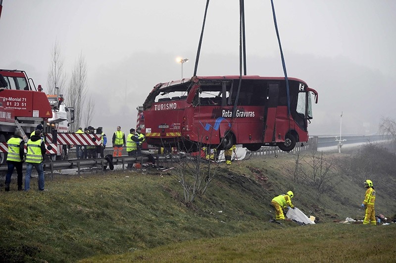 Firefighters and gendarmes work at the site of a bus crash, near Charolles, central France, on Jan. 8, 2017. (AFP Photo)