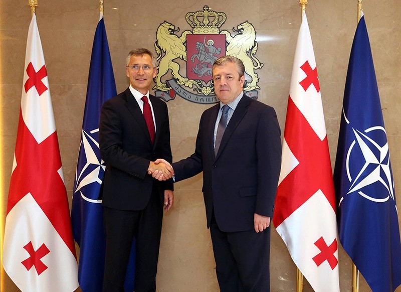 NATO Secretary-General Jens Stoltenberg (L) shakes hands with Georgian PM Giorgi Kvirikashvili. (AA Photo)