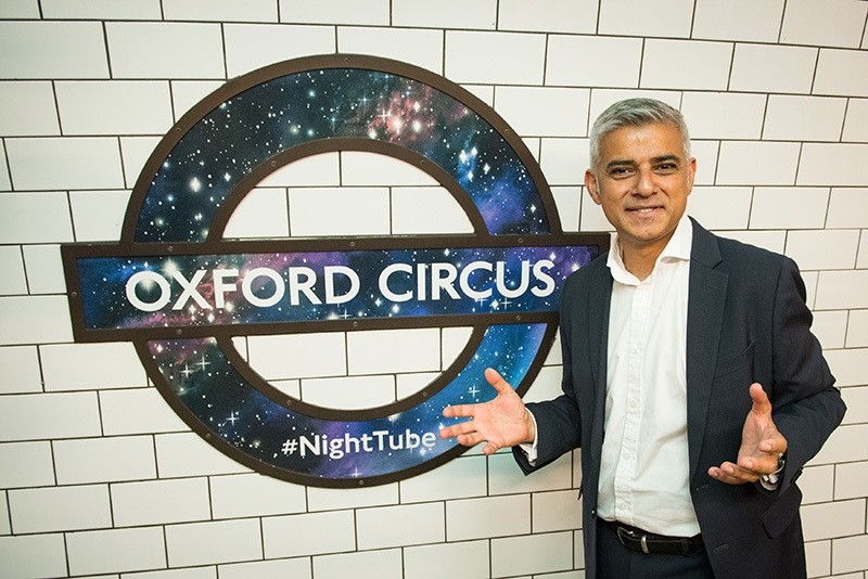 Mayor of London Sadiq Khan poses in front of a new Night Tube logo at Oxford Circus underground station, in London Thursday Aug. 18, 2016. (AP Photo)