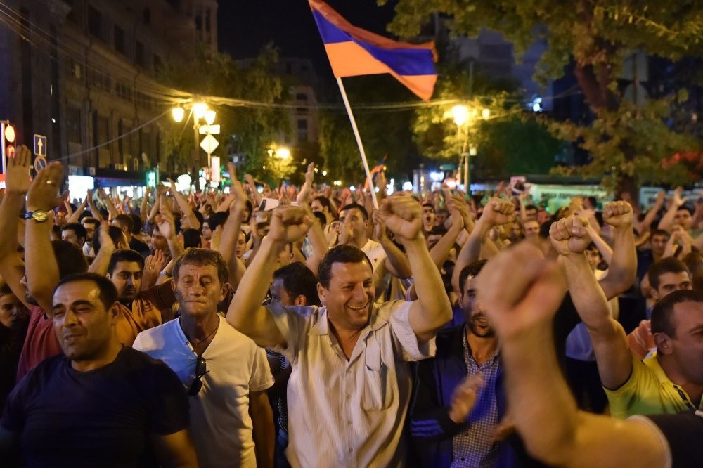 Supporters of the opposition hold a protest march in support of the occupation of the Patrol-Guard Service Regiment of Erebuni district in Yerevan, Armenia, 26 July, 2016. Protestors demanded the resignation of Armenian President Serzh Sargsyan.