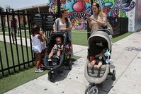 Vanessa Gomez, 33, left, with her son Ezra, 2, and her friend Cristy Fernandez, 33, with her 9-month-old- son River, of Miami, walk in the Wynwood neighborhood of Miami, Friday, July 29, 2016. (AP Photo)