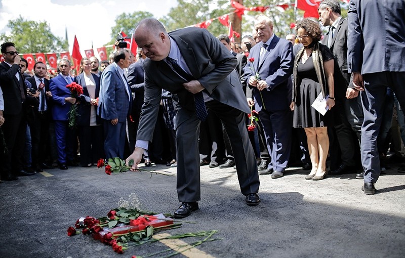 Consuls of European countries leave cloves on June 8, 2016 on the site of yesterday's bomb attack that killed 11 people including several police officers, in the Vezneciler district of Istanbul.