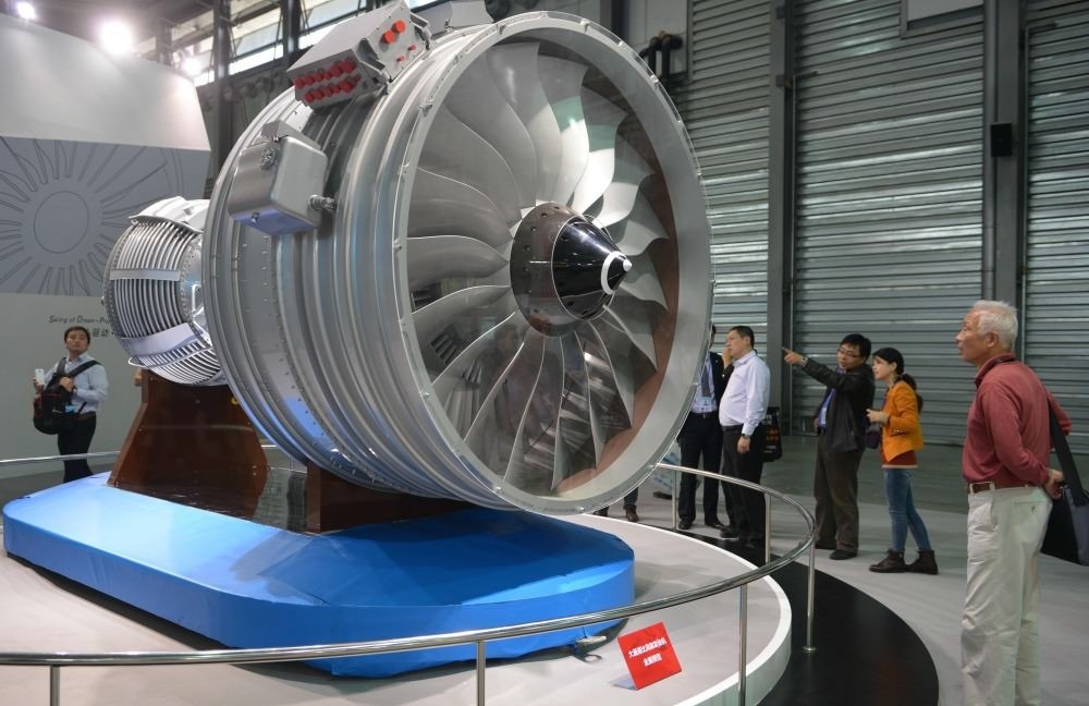 Visitors looking at a full-size model of an aircraft jet engine made by the China Aviation Industry Corporation at the China International Industry Fair in Shanghai.