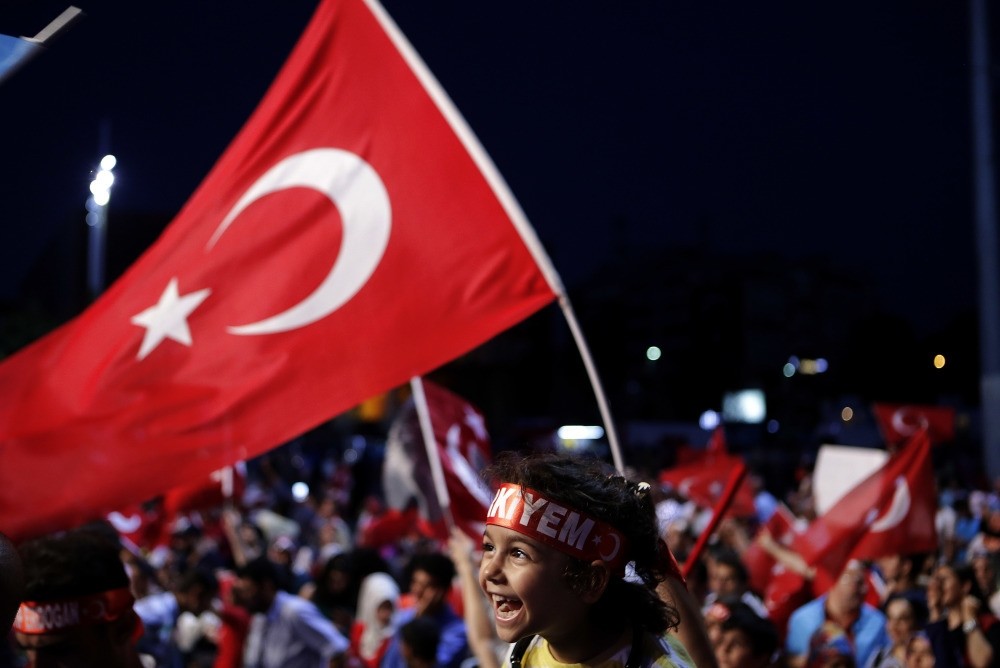 A child siting on the shoulders of an adult during an anti-coup rally at Taksim Square in central Istanbul, July 31.