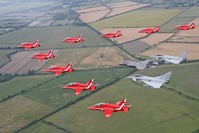 Jet aircraft from the British Royal Air Force Aerobatic Team, the Red Arrows, in formation with two Typhoons and the F-35B Lightning II over Gloucestershire.