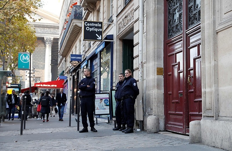 This file photo taken at the Rue Tronchet, near Madeleine, central Paris, on October 3, 2016 shows police officers standing guard at the entrance of the hotel residence (AFP Photo)