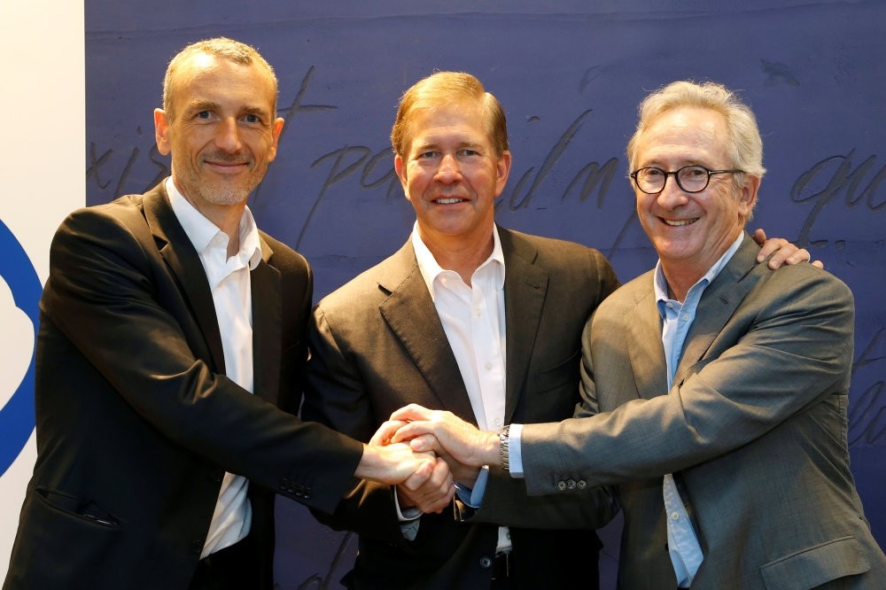 From L-R, Emmanuel Faber, CEO of Danone, Gregg Engles, CEO of WhiteWave Foods Company, and Franck Riboud, Chairman of French food group Danone, pose before the start of a news conference in Paris. (Reuters Photo)