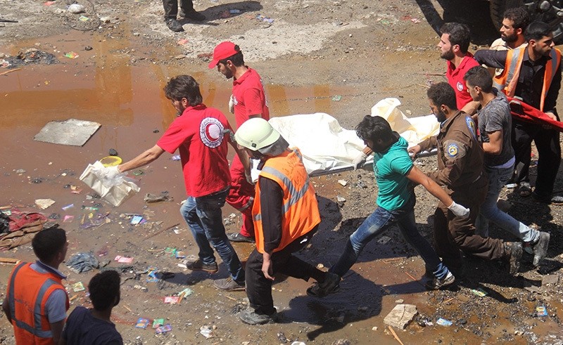 Representative photo: Syrian Red Crescent members carry the body of a victim on a stretcher following air strikes on the northwestern city of Idlib, on June 12, 2016. (AFP)