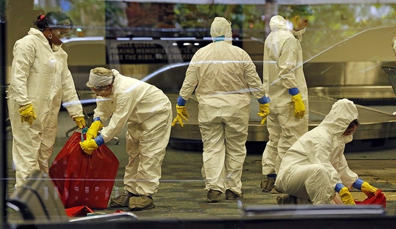 A hazmat crew cleans up baggage claim Terminal Two on Saturday, Jan. 7, 2017 at Fort Lauderdale-Hollywood International Airport Terminal the day after multiple people were shot on Friday. (AP Photo)