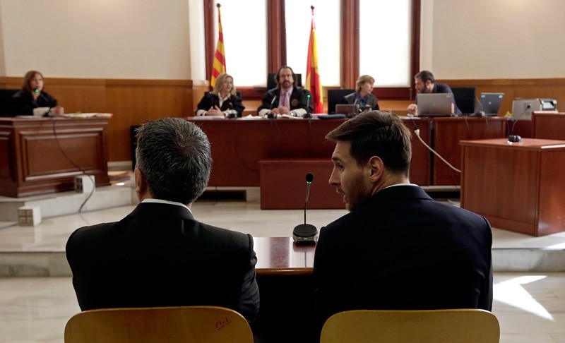 Barcelona's Lionel Messi, right, and his father Jorge Horacio Messi sit in court in Barcelona, Spain, Thursday June 2, 2016.   AP Photo