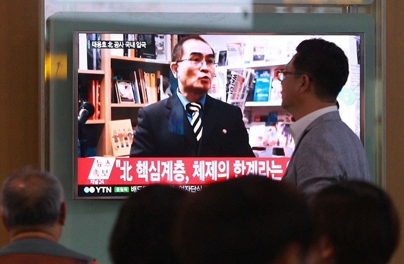 In this Wednesday, Aug. 17, 2016 file photo, people watch a TV news program showing a file image of Thae Yong Ho, a minister at the North Korean Embassy in London, at Seoul Railway Station in Seoul, South Korea. (AP Photo)
