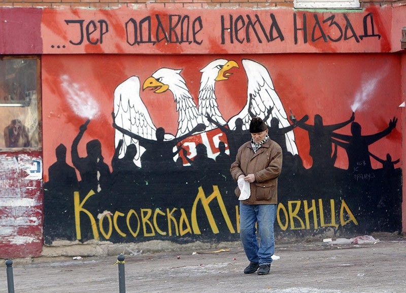 A Serb resident of the northern part of Kosovska Mitrovica passes by a graffiti reading 'From here there is no way back' in the northern part of Kosovska Mitrovica, Kosovo on Jan. 15, 2017. (EPA Photo)