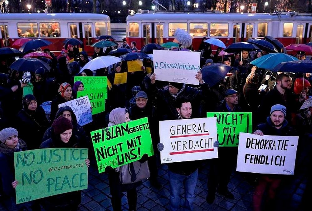 Protesters holding banners during a demonstration under the slogan u201cNew Islam law? Not with us!u201d in front of the parliament building in Vienna.