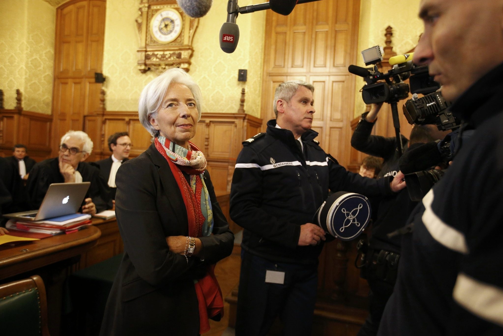 Lagarde (L) reacts before the start of her trial about a state payout in 2008 to a French businessman, at the courts in Paris. (REUTERS PHOTO)
