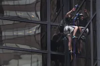 A man scales Trump Tower using suction cups, Wednesday, Aug. 10, 2016, in New York. (AP Photo)