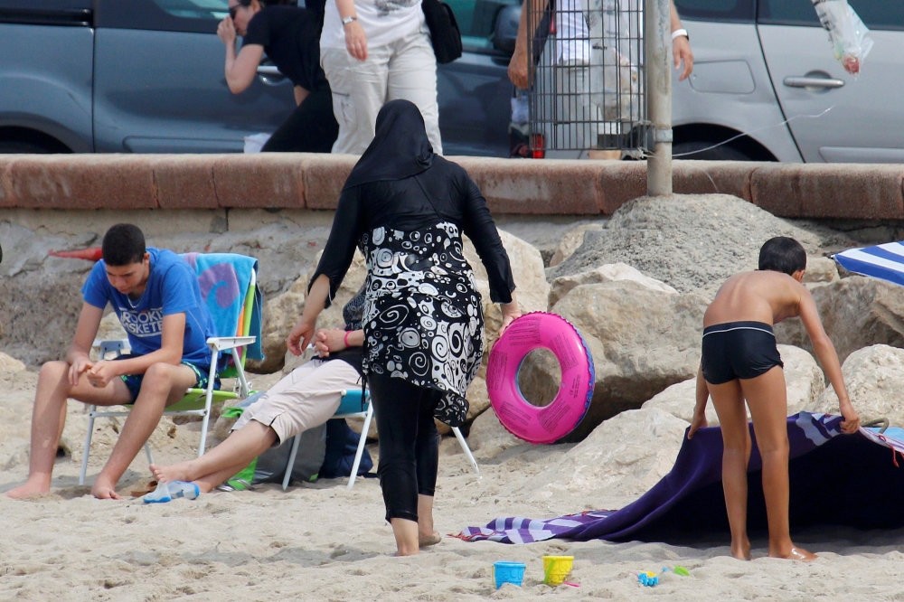 A Muslim woman wears a burkini on a beach in Marseille, France, Aug. 17