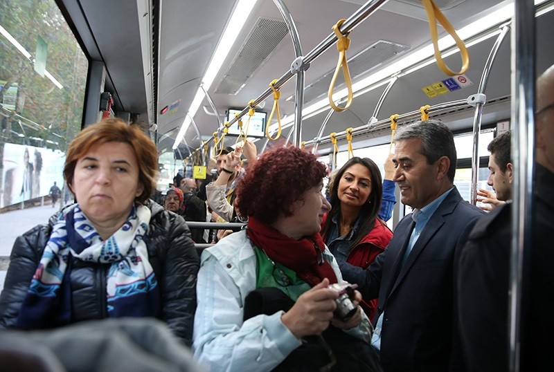 IETT General Manager Arif Emecen (R) talks with the passengers in a bus on Oct. 7 during the 'Empathy Week,' held since 2012 to increase quality of public transport. (AA Photo)