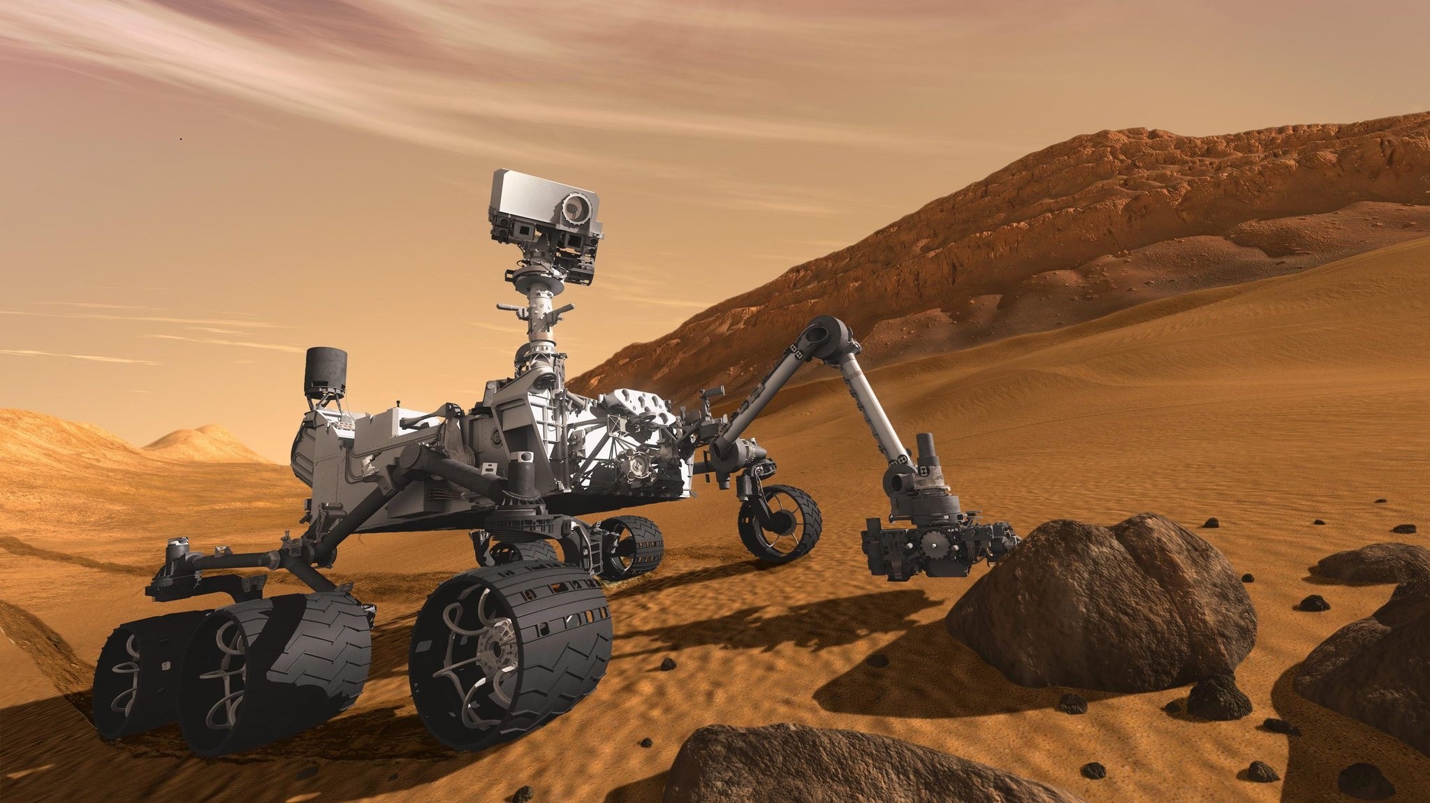 In this 2011 artist's rendering provided by NASA/JPL-Caltech, the Mars Science Laboratory Curiosity rover examines a rock on Mars with a set of tools at the end of its arm, which extends about 2 meters. (AP Photo)