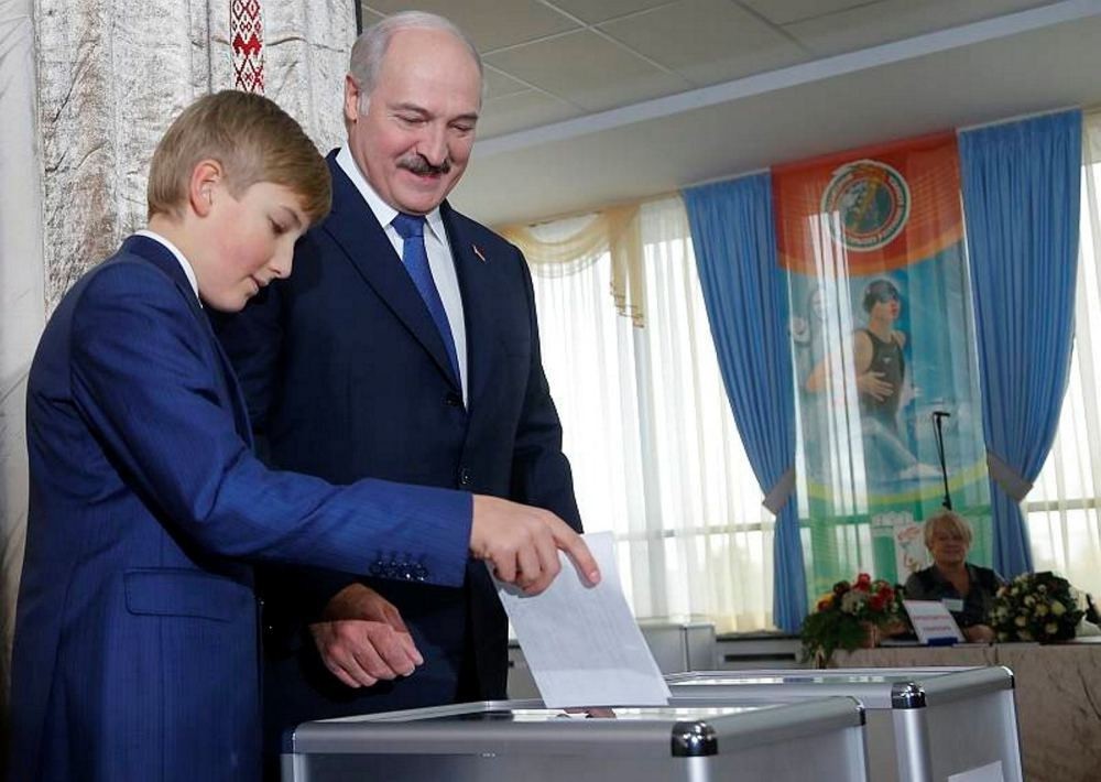 Belarusian President Alexander Lukashenko with his youngest son Nikolai casts his ballot at a polling station, during the presidential election, in Minsk, Belarus, Oct. 11, 2015.